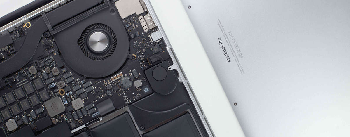 The interior of a macbook pro showing main board and fan.
