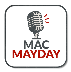 A smiling woman sat in her office with her Mac laptop and organic produce around her.